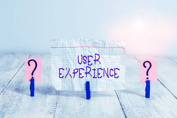 Conceptual hand writing showing User Experience. Business photo showcasing the overall experience of a demonstrating using a product Crumbling sheet with paper clips placed on the wooden table. - Photo, Image