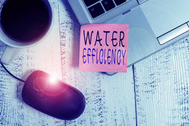 Word writing text Water Efficiency. Business concept for reduce water wastage by measuring amount of water required Trendy metallic laptop blank sticky note coffee cup mouse lying vintage. - Photo, Image