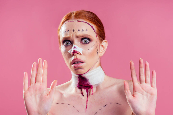 caucasian panic female cosmetic lifting procedure in studio pink background - Foto, imagen