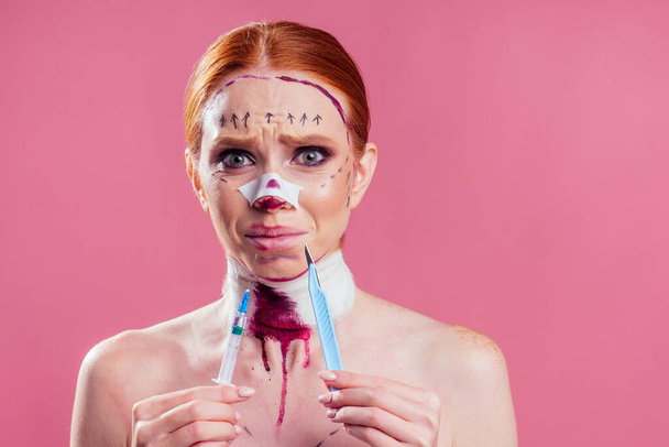 caucasian panic female cosmetic lifting procedure in studio pink background - Foto, imagen