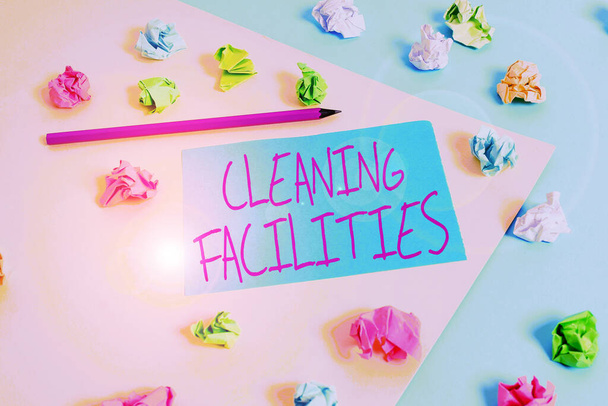 Writing note showing Cleaning Facilities. Business photo showcasing Place or equipment provided for a cleaning purposes Colored crumpled papers empty reminder blue yellow clothespin. - Photo, Image