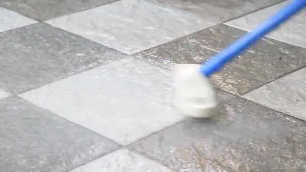Cleaning the tile floor with floor scrubber brush. - Footage, Video