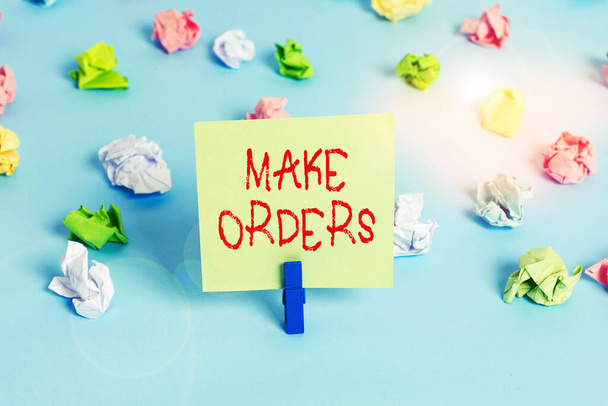 Word writing text Make Orders. Business concept for A confirmed request by one party to another to buy or sell Colored crumpled papers empty reminder blue floor background clothespin. - Photo, Image