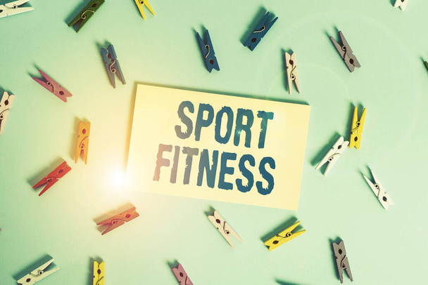 Conceptual hand writing showing Sport Fitness. Business photo text Conditioning athletes for the unique Demands of their sports Colored clothespin rectangle shaped paper blue background. - Zdjęcie, obraz