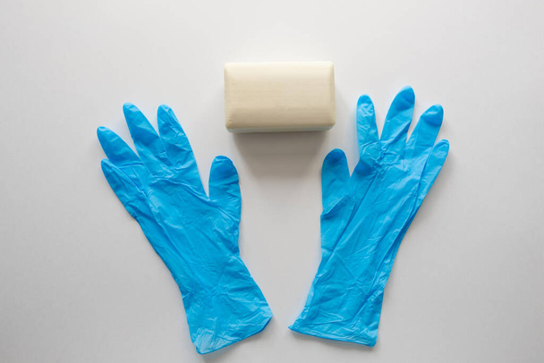 Pair of latex medical gloves, medical masks, sanitizer gel for hand hygiene, remedies, soap, disinfector. Coronavirus prevention - 写真・画像