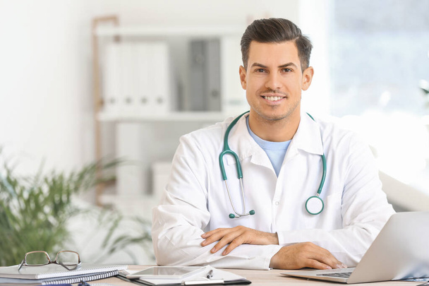 Young male doctor working in clinic - Photo, Image