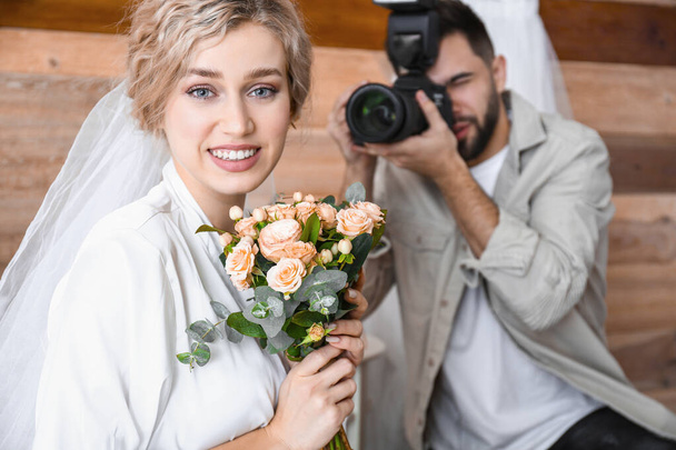 Φωτογράφος λαμβάνοντας νύφη ετοιμάζεται φωτογραφίες στο στούντιο - Φωτογραφία, εικόνα