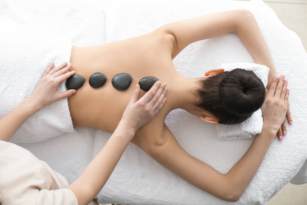 Beautiful young woman receiving massage in spa salon - Fotografie, Obrázek