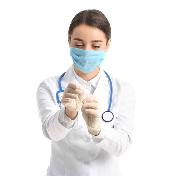 Doctor wearing medical mask against white background - 写真・画像