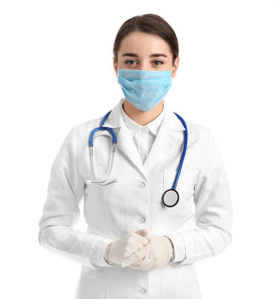 Doctor wearing medical mask against white background - Foto, afbeelding