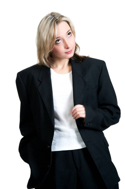 Beautiful sexy blonde girl in black trousers, jacket and shirt on a white background isolation - Fotó, kép