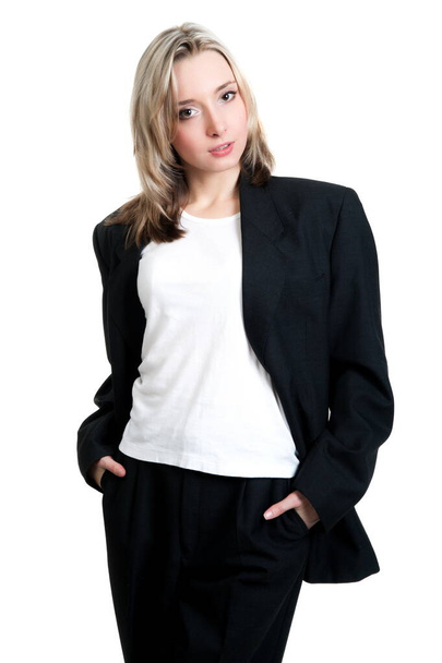 Beautiful sexy blonde girl in black trousers, jacket and shirt on a white background isolation - Foto, imagen