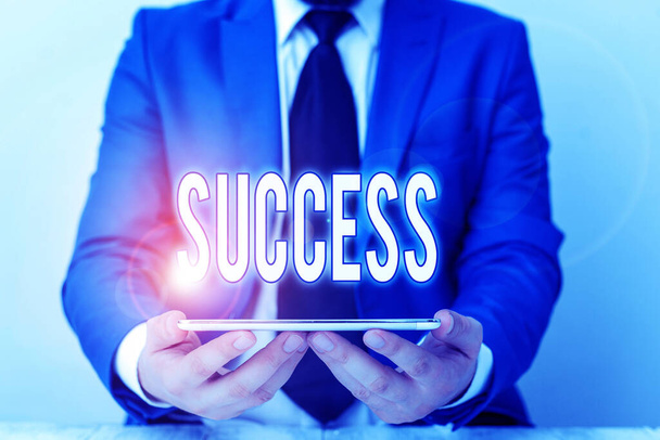 Word writing text Success. Business concept for accomplishment aim purpose good or bad outcome of undertaking Businessman in blue suite with a tie holds lap top in hands. - Foto, immagini