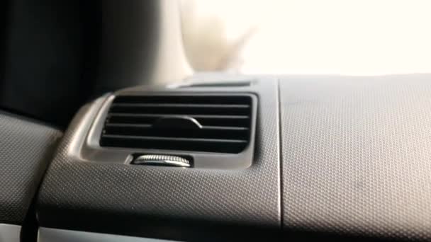 Close-up of passenger hand tuning air ventilation grille or adjusting the air conditioner button in the car. - Footage, Video