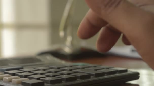 A businessman typing hand calculating numbers. Fingers pressing the buttons of calculator. Close up of Press the right button. Calculator with finger. Counting on vintage background isolated. - Footage, Video