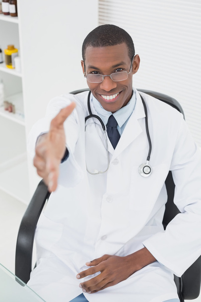 Doctor offering a handshake at medical office - Photo, image