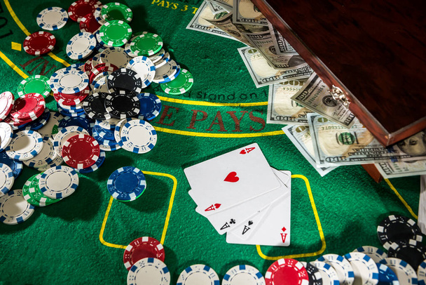 Faház pókerzsetonokhoz kártyákkal és amerikai dollárral a zöld asztalon. Szerencsejáték koncepció - Fotó, kép