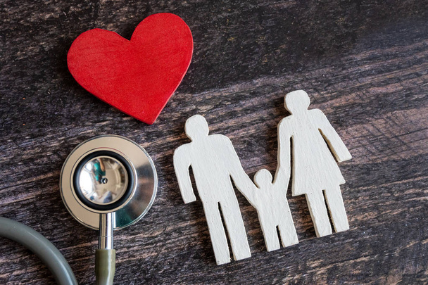 Rode hart, stethoscoop en icoon familie op houten bureau. Ziekteverzekering Concept - Foto, afbeelding