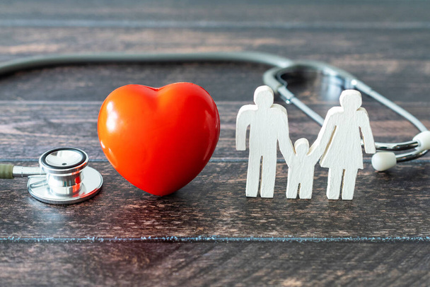 Red heart, stethoscope and icon family on wooden desk. Medical Insurance Concept - Fotografie, Obrázek