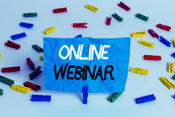Handwriting text writing Online Webinar. Concept meaning online meeting or presentation held via the Internet Colored clothespin papers empty reminder white floor background office. - Photo, Image