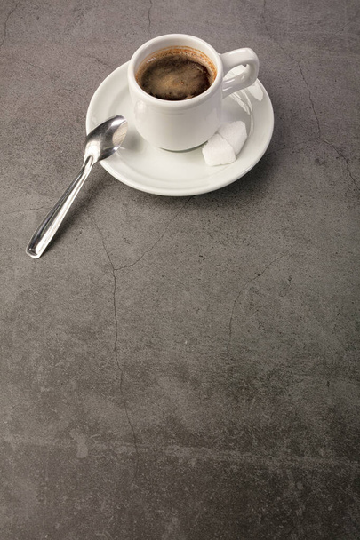 Coffee cup with spoon and sugar on a dark background - Fotoğraf, Görsel