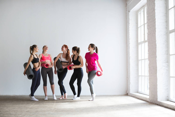 Happy group of fit women at the gym. Fitness, yoga, exercise. - Фото, зображення