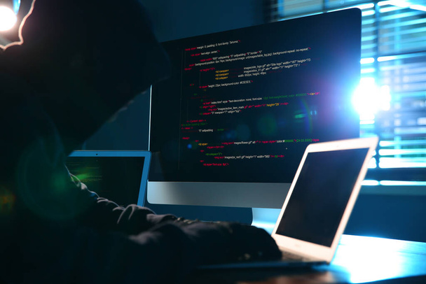 Hacker with computers in dark room. Cyber crime - Фото, зображення