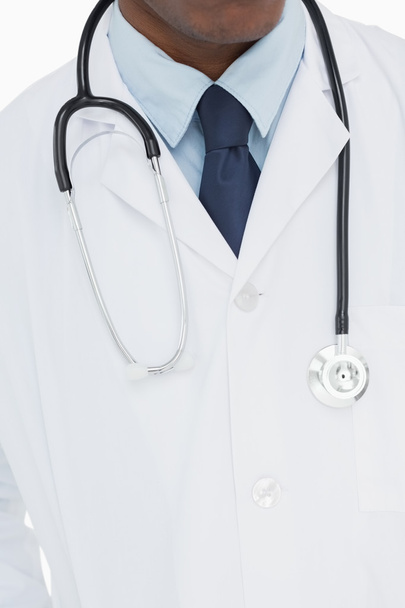 Mid section of a male doctor in lab coat and with stethoscope - Photo, Image