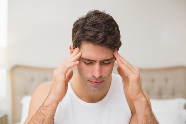 Man suffering from headache in bed - Фото, зображення