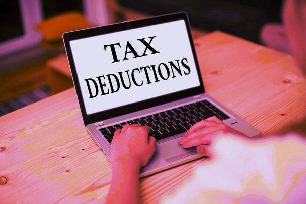 Writing note showing Tax Deductions. Business photo showcasing amount or cost that can be subtracted from someone s is income. - Photo, Image
