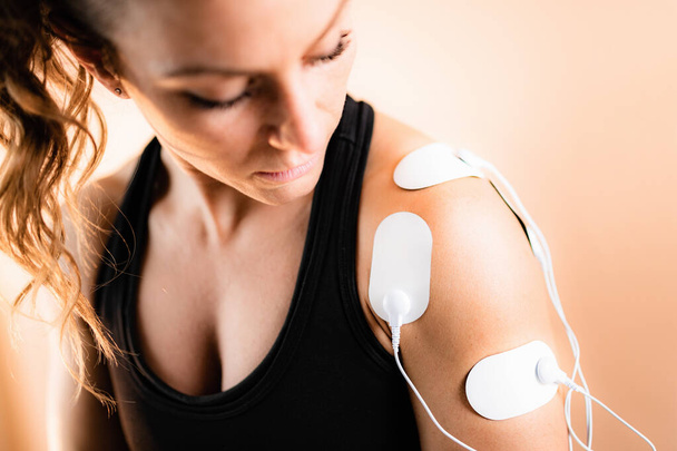 Shoulder Physical Therapy with TENS Electrode Pads, Transcutaneous Electrical Nerve Stimulation.   - Photo, Image