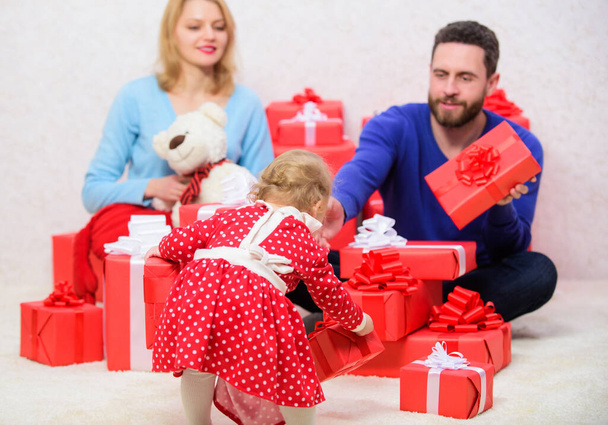 Valentines day. Red boxes. Shopping online. Boxing day. Love and trust in family. Bearded man and woman with little girl. father, mother and doughter child. Happy family with present box. True love - Photo, image