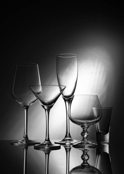 Five glass goblets on a gray gradient background - Photo, Image