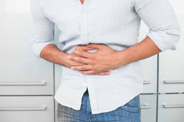 Mid section of man suffering from stomach pain - Photo, Image