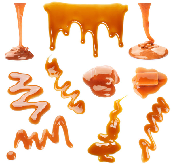 Set with caramel candies and tasty sauce on white background - Photo, image