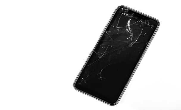 broken smartphone with screen damage isolated on white background - Photo, Image