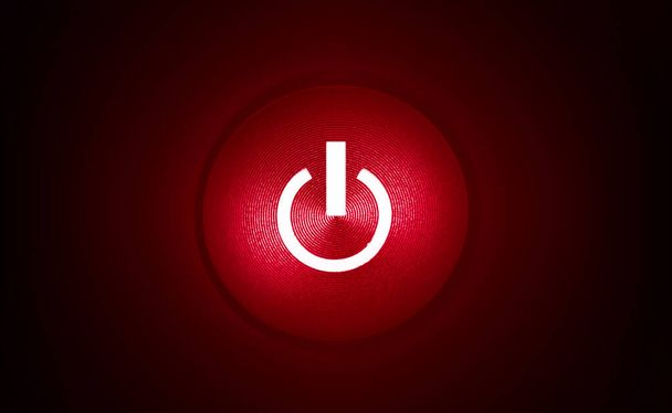 червона кнопка живлення з червоним світлом на темному, чорному фоні
 - Фото, зображення