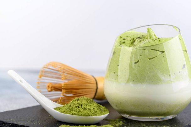 Dalgona Matcha Latte, a creamy whipped matcha, on light background. Matcha green tea. - Photo, Image