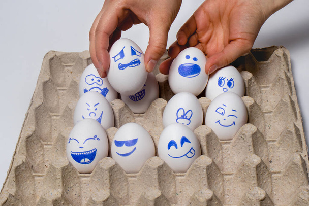 Funny chicken eggs. Smiley eggs with faces, funny faces. Eggs with different emotions: laughter, smiles, fear, anger, scream, tears. - Photo, Image