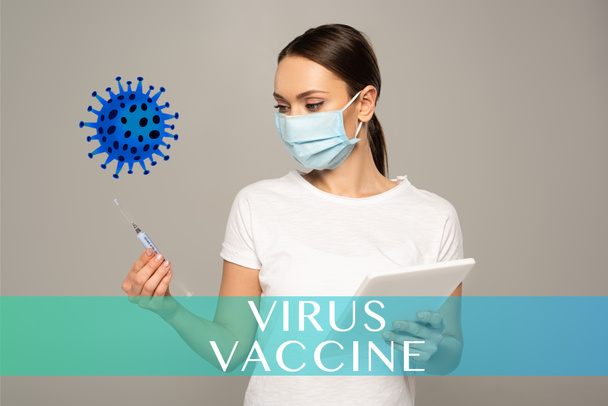 Girl in medical mask holding syringe and digital tablet isolated on grey, virus vaccine illustration   - Photo, Image