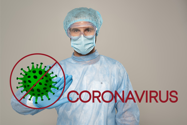 Doctor in medical mask showing stop gesture at camera isolated on grey, bacteria and coronavirus illustration - Photo, Image