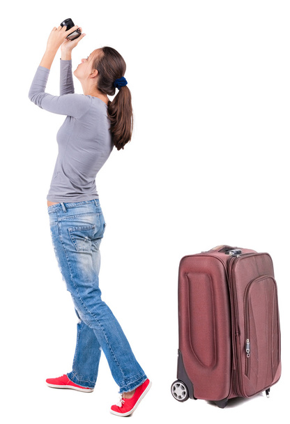 Back view of woman photographing traveling with suitcase. - Foto, Bild