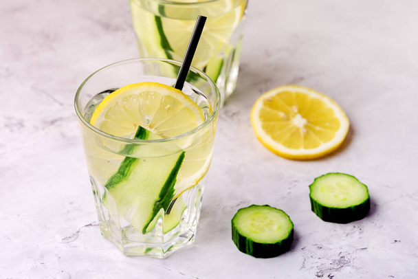 Glasses of Healthy Detox Water with Lemon and Cucumbers Diet Drink Straw Horizontal Above - Fotó, kép