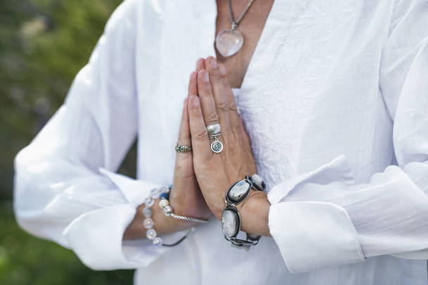 Close up image of female hands in prayer position outdoor. Self-care practice for wellbeing - Foto, immagini