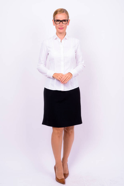 Studio shot of beautiful blonde businesswoman against white background - Zdjęcie, obraz