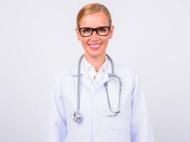 Studio shot of beautiful blonde woman doctor against white background - Foto, afbeelding