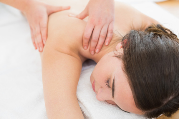 Woman enjoying back massage at beauty spa - Fotó, kép
