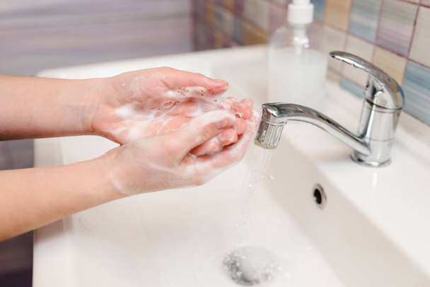 Coronavirus prevention. Wash hands with antibacterial soap, warm water rubbing nails and fingers in sink. Washing hands and hygiene. Covid-19. Prevention of flu disease. To stop spreading coronavirus. - Photo, Image