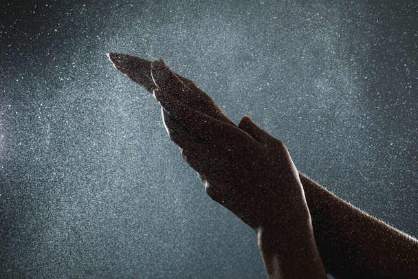 Closeup washing hands with an antiseptic aerosol sanitizer - 写真・画像