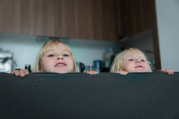 little girls staying home, kids play hide and seek indoors - Foto, Imagen